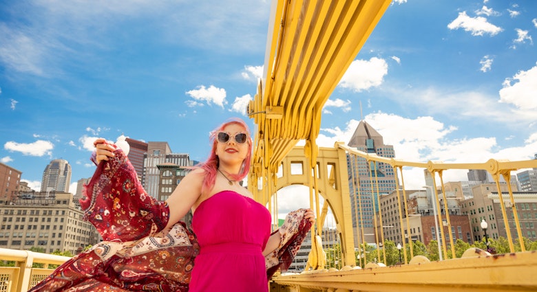 A beautiful 17 year old girl with pink hair enjoying a rare sunny day on the Roberto Clemente Bridge in downtown Pittsburgh, PA, USA.