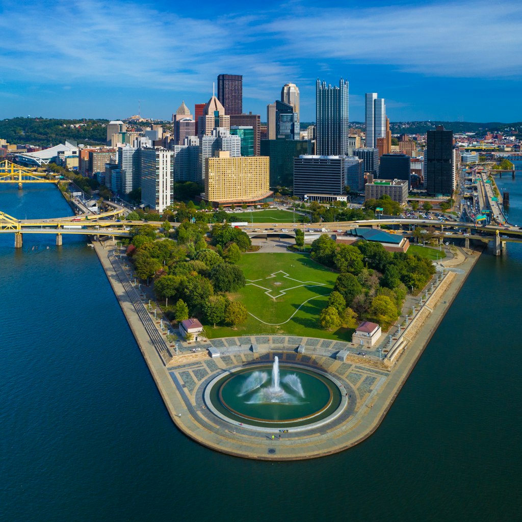 Downtown Pittsburgh skyline aerial view with Fort Duquesne (including a fountain), Point State Park, I-279, Allegheny River (left), Fort Duquesne Bridge (left), Monongahela River (right) and Fort Pitt Bridge (right) in the foreground.