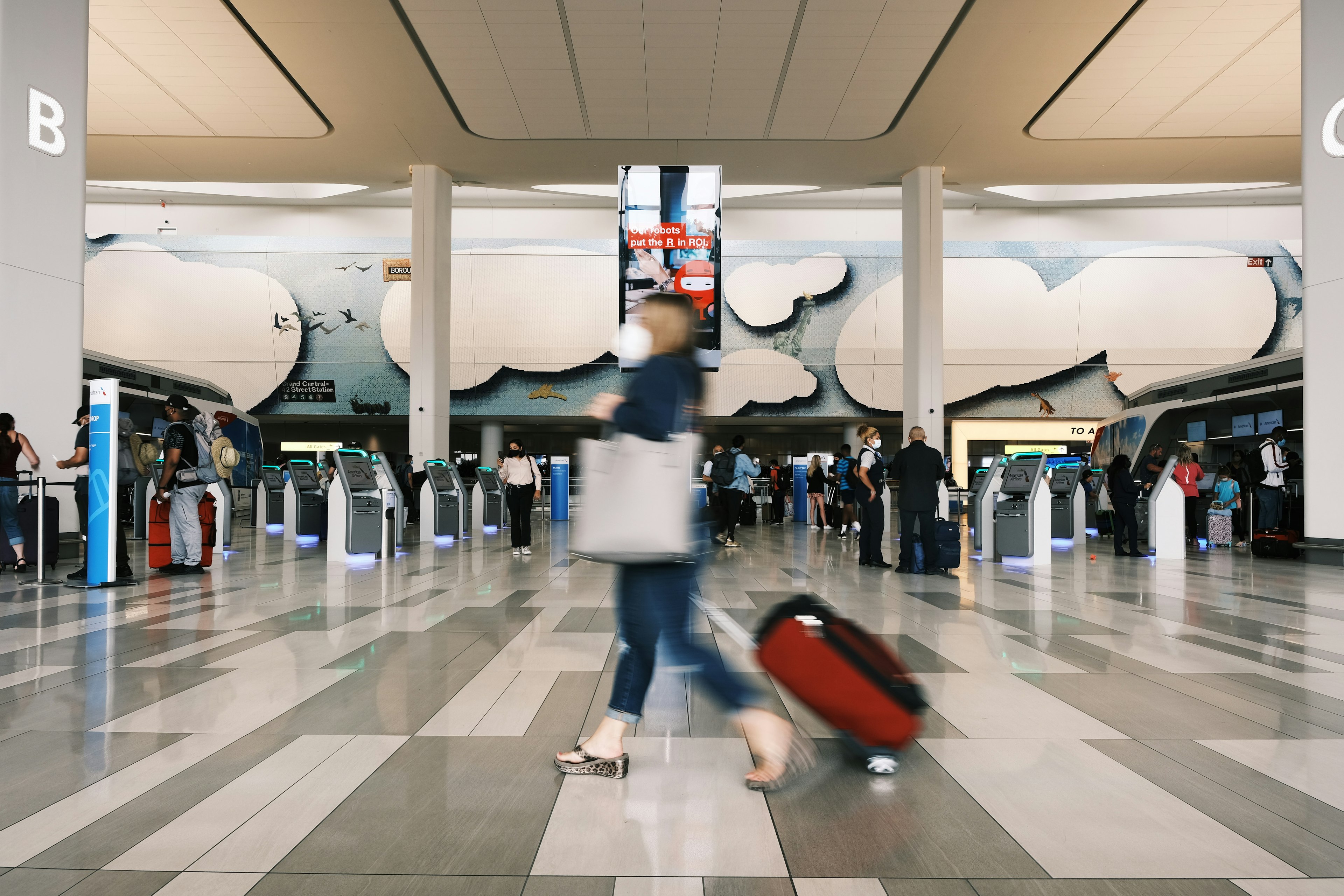 People move through LaGuardia Airport in New York City