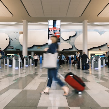 NEW YORK CITY - JULY 02: People move through LaGuardia Airport (LGA) before the start of the Fourth of July weekend on July 02, 2021 in New York City. Following a year that saw the airline and travel industries lose billions of dollars due to the pandemic, Americans are traveling again with officials warning travelers to prepare for long lines and increased wait times at airports this holiday weekend. (Photo by Spencer Platt/Getty Images)