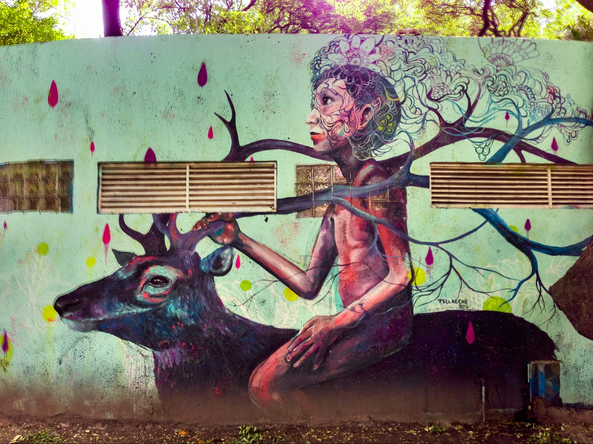 Colorful street art mural of a young person riding an elk painted on a large wall in the neighborhood of Condesa, Mexico City