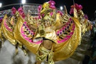 February 9, 2018: Women dance in elaborate gold costumes at the Parade of the Samba Schools of the Special Group during the Carnival of Rio de Janeiro.