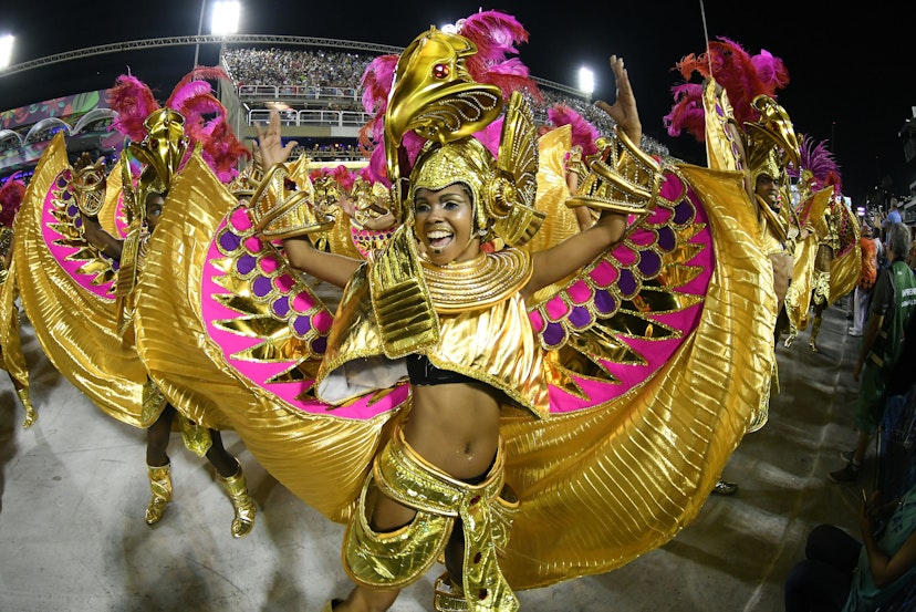 February 9, 2018: Women dance in elaborate gold costumes at the Parade of the Samba Schools of the Special Group during the Carnival of Rio de Janeiro.