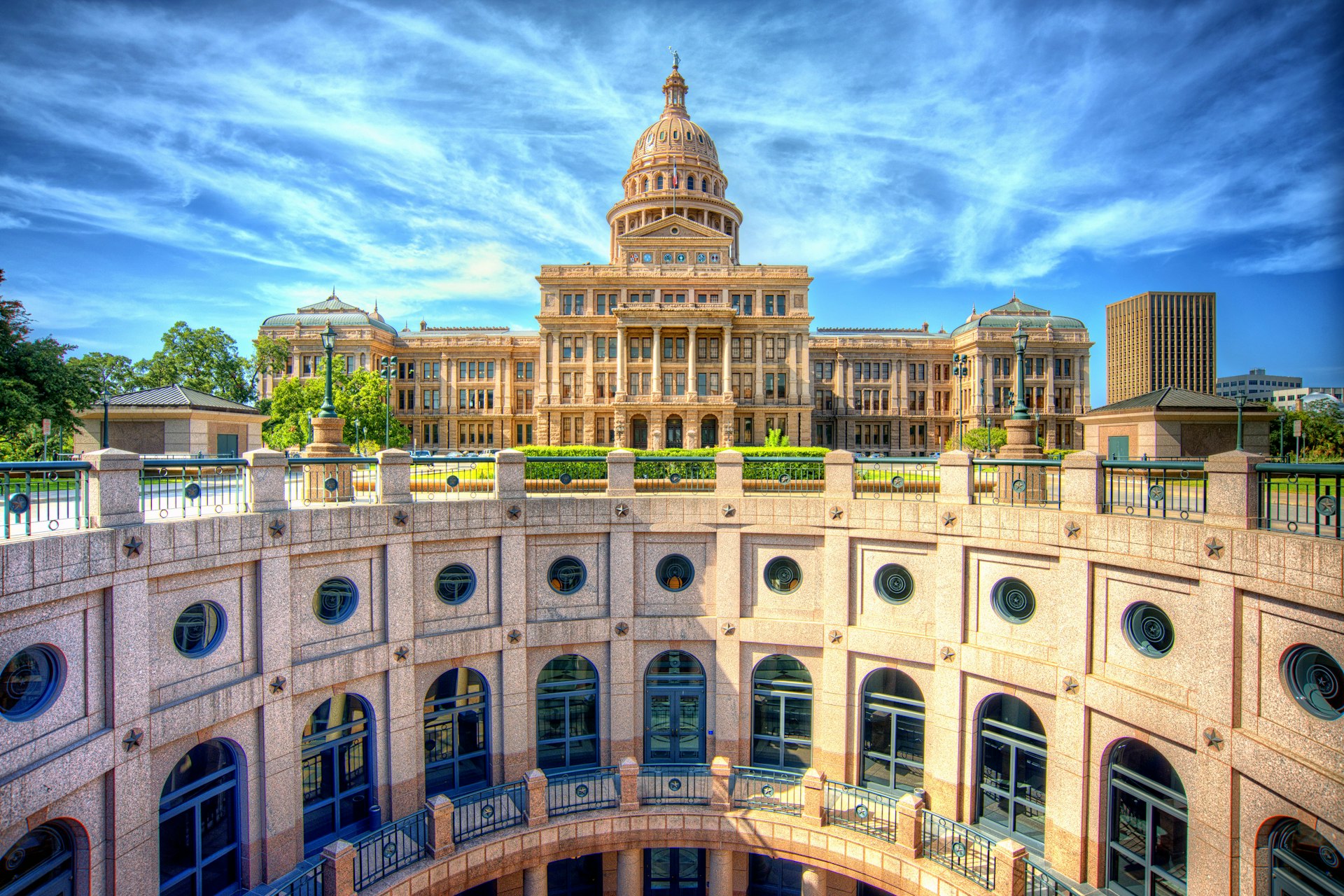 The stunning rotunda of the Texas State Capitol with the main building in the background