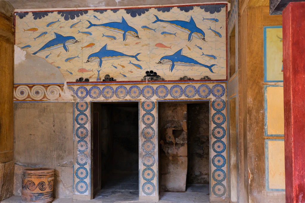 shutterstockRF_1516170275.jpg Dolphin frescoes above a doorway in the Palace of Knossos. The frescoes depict blue dolphins and are highly detailed.