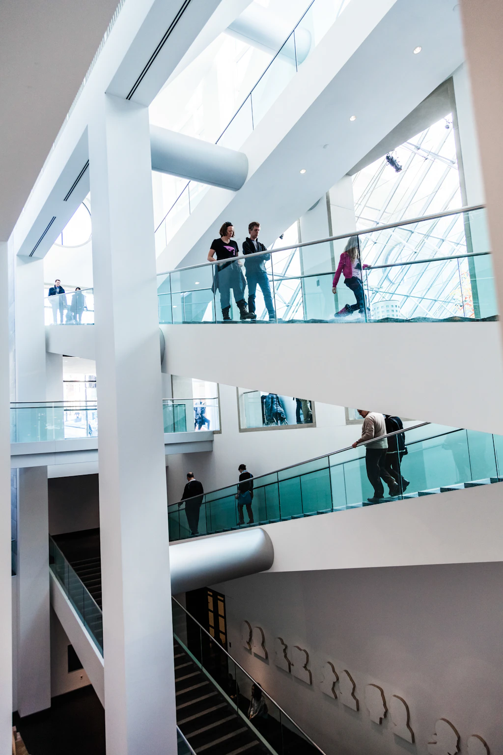Fine Arts Museum, Montreal People walking on two separate sets of stairs that are bathed in natural light