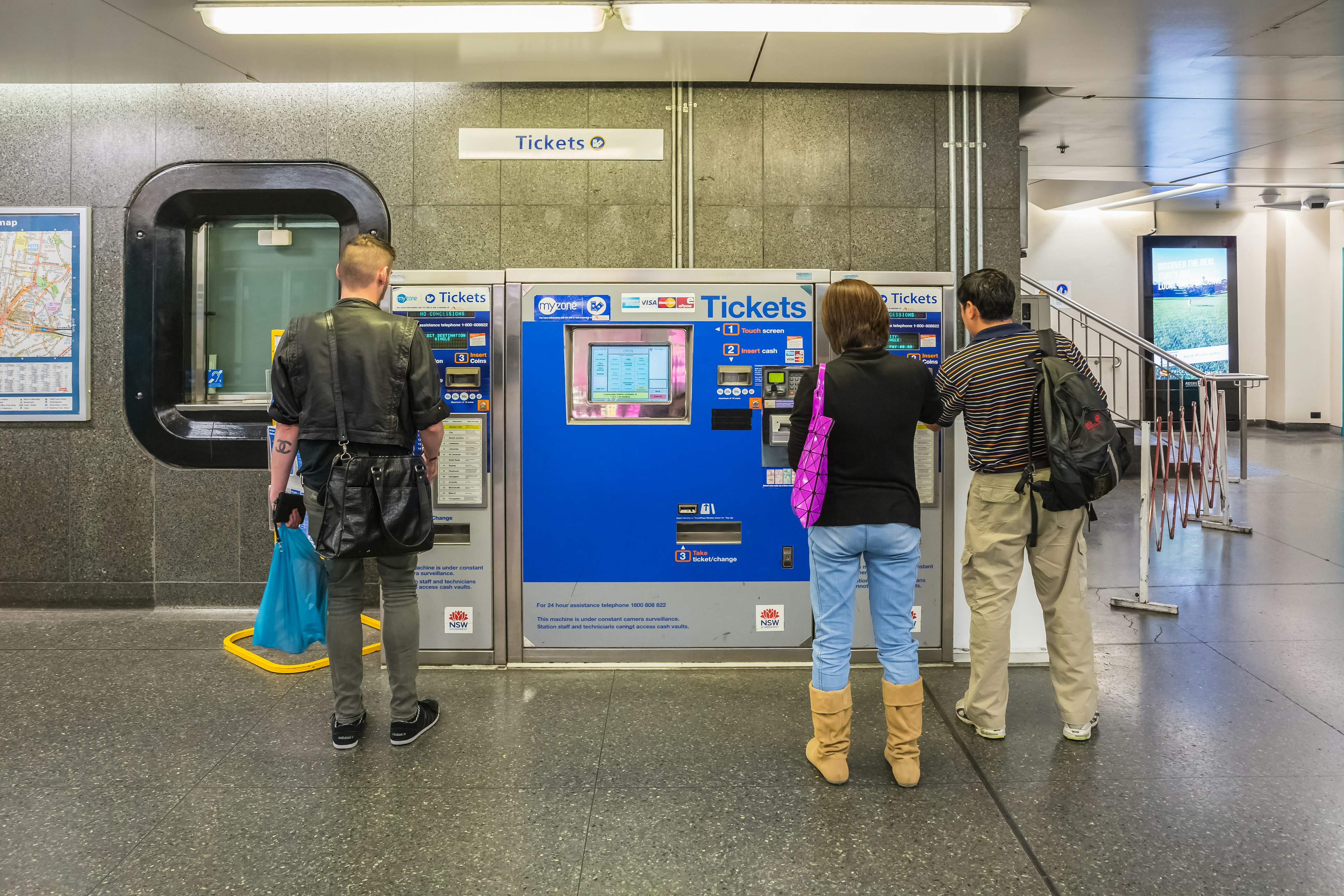 Buying ticket from vending machine in King Cross train station Sydney