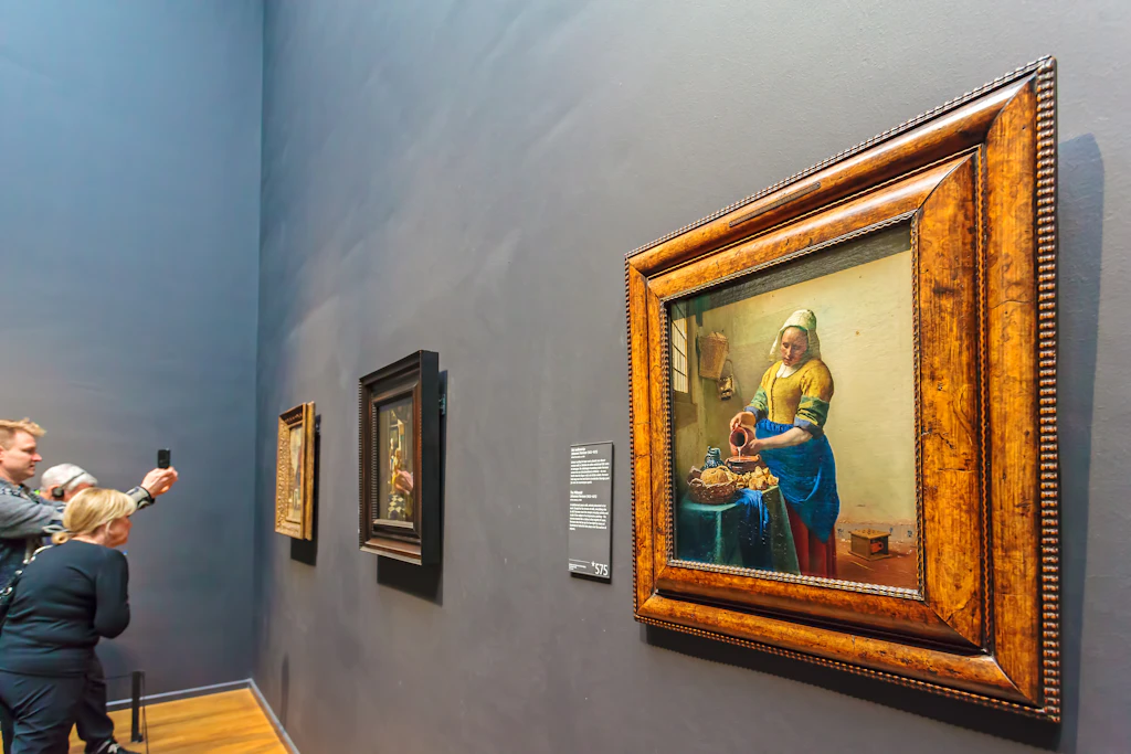 Oil Painting of The Milkmaid by Johannes Vermeer from 1658 in the famous Rijksmuseum in Amsterdam at the museumplein, The Netherlands 