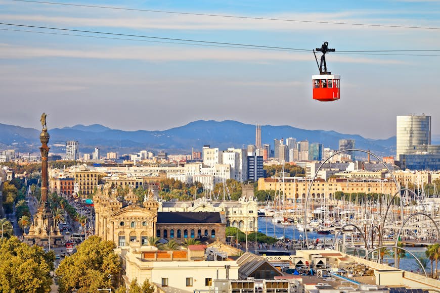 Red cabin of cableway stands out on Barcelona's city backdrop