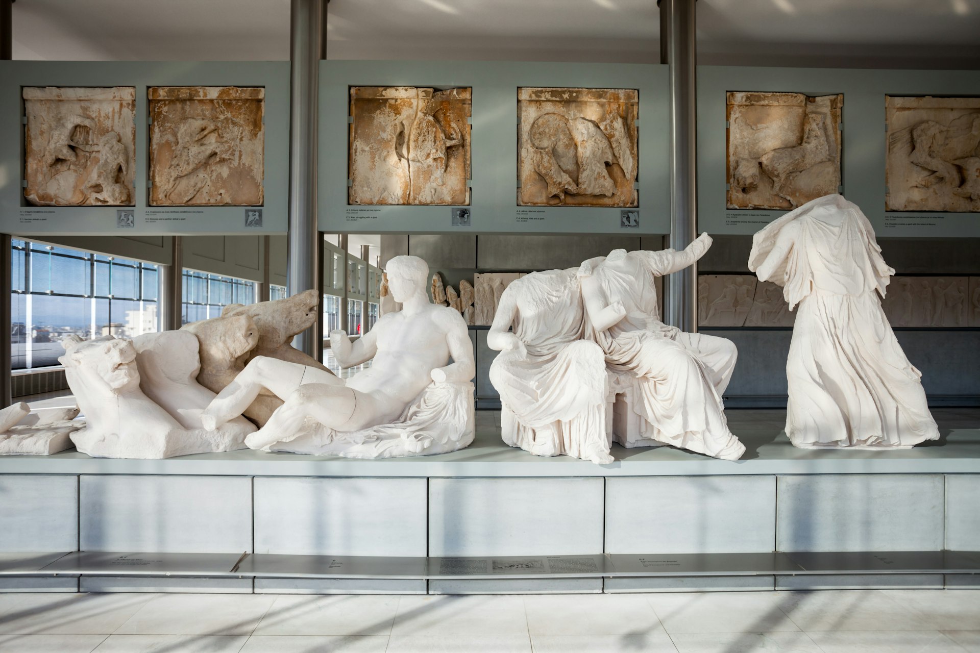Several statues on display at the Acropolis Museum, an archaeological museum focused on the findings of the archaeological site of the Acropolis of Athens in Greece