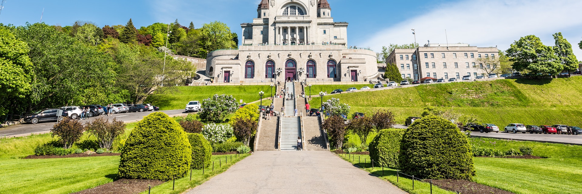 May 28, 2017: St Joseph's Oratory on Mont Royal with a woman praying on steps.
