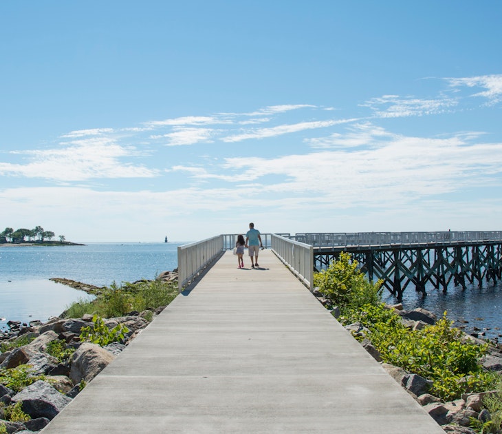 A view down the pier boardwalk on a beautiful summer day by the Long Island Sound at Calf Pasture Beach in Norwalk, Connecticut USA; Shutterstock ID 1768878476; your: Tasmin Waby; gl: 65050; netsuite: Online editorial; full: Demand project