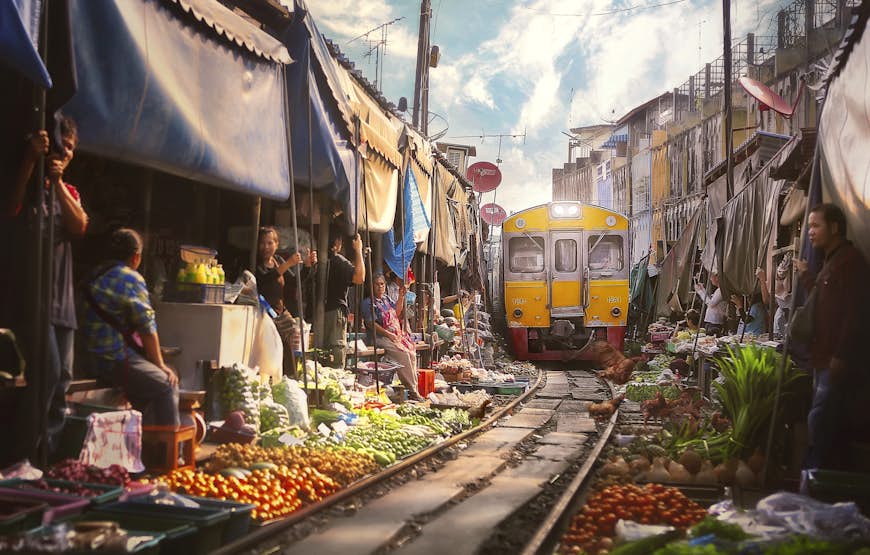 The Bangkok train arriving at the Samut Sakhon Railway Market 