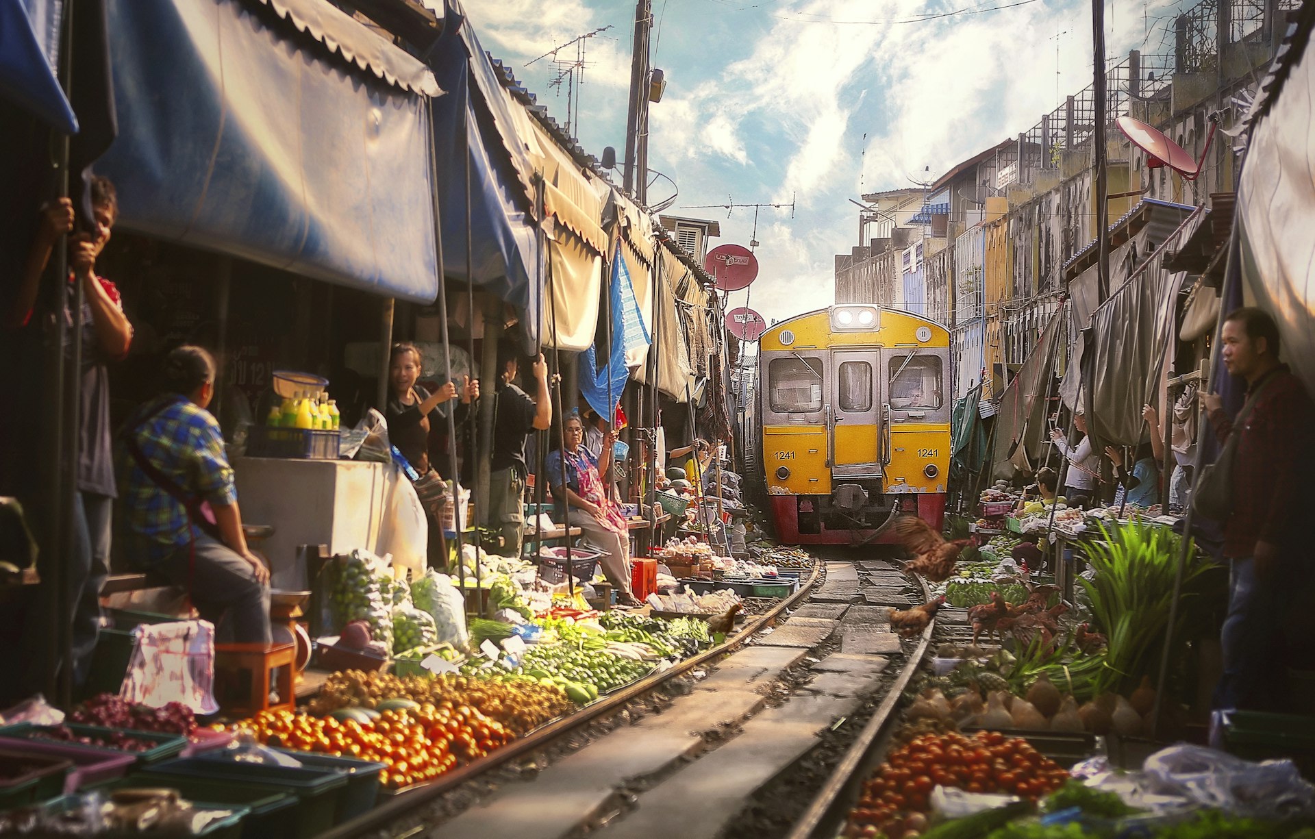 The Bangkok train arriving at the Samut Sakhon Railway Market 