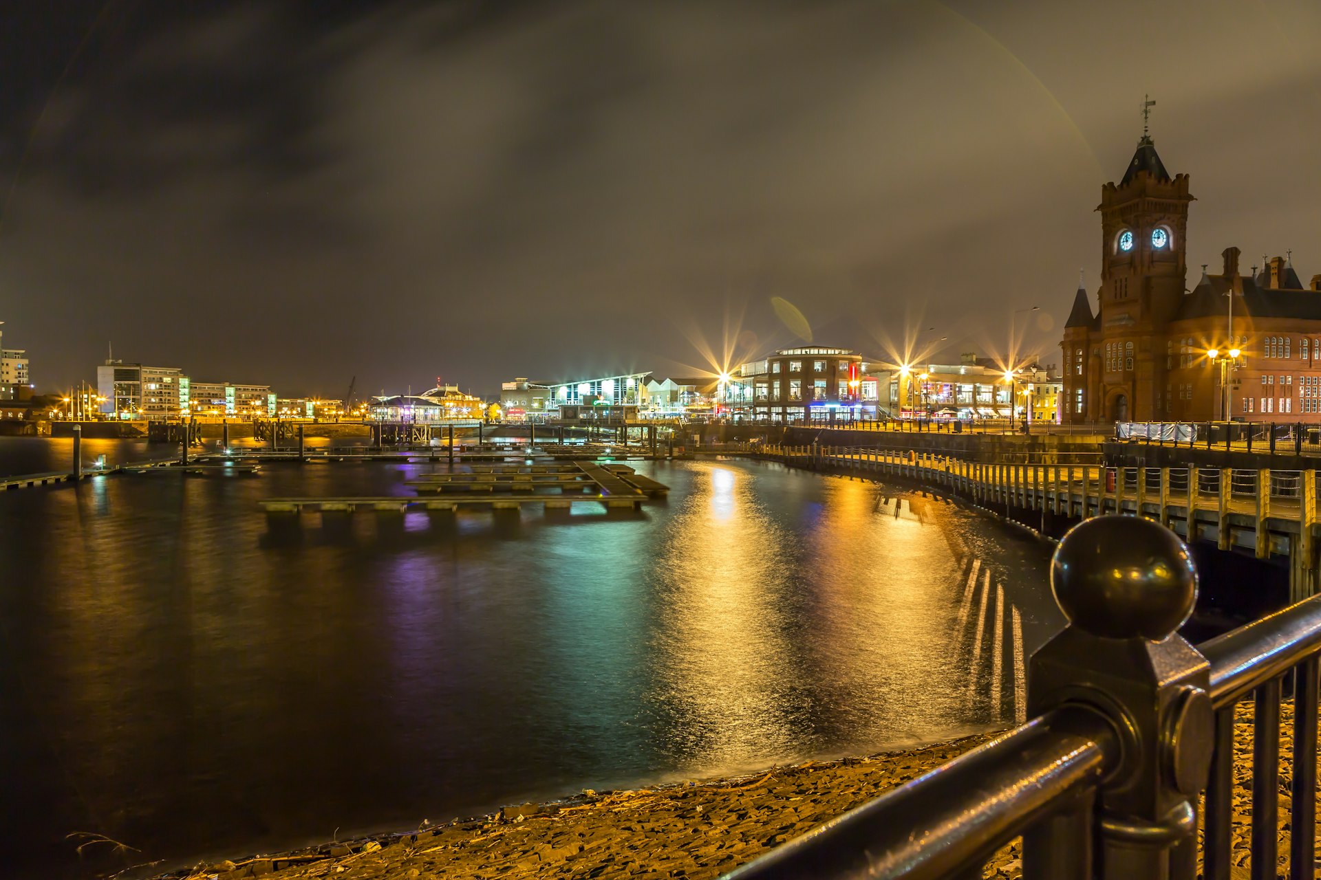 Lit-up buildings along Cardiff Bay at night