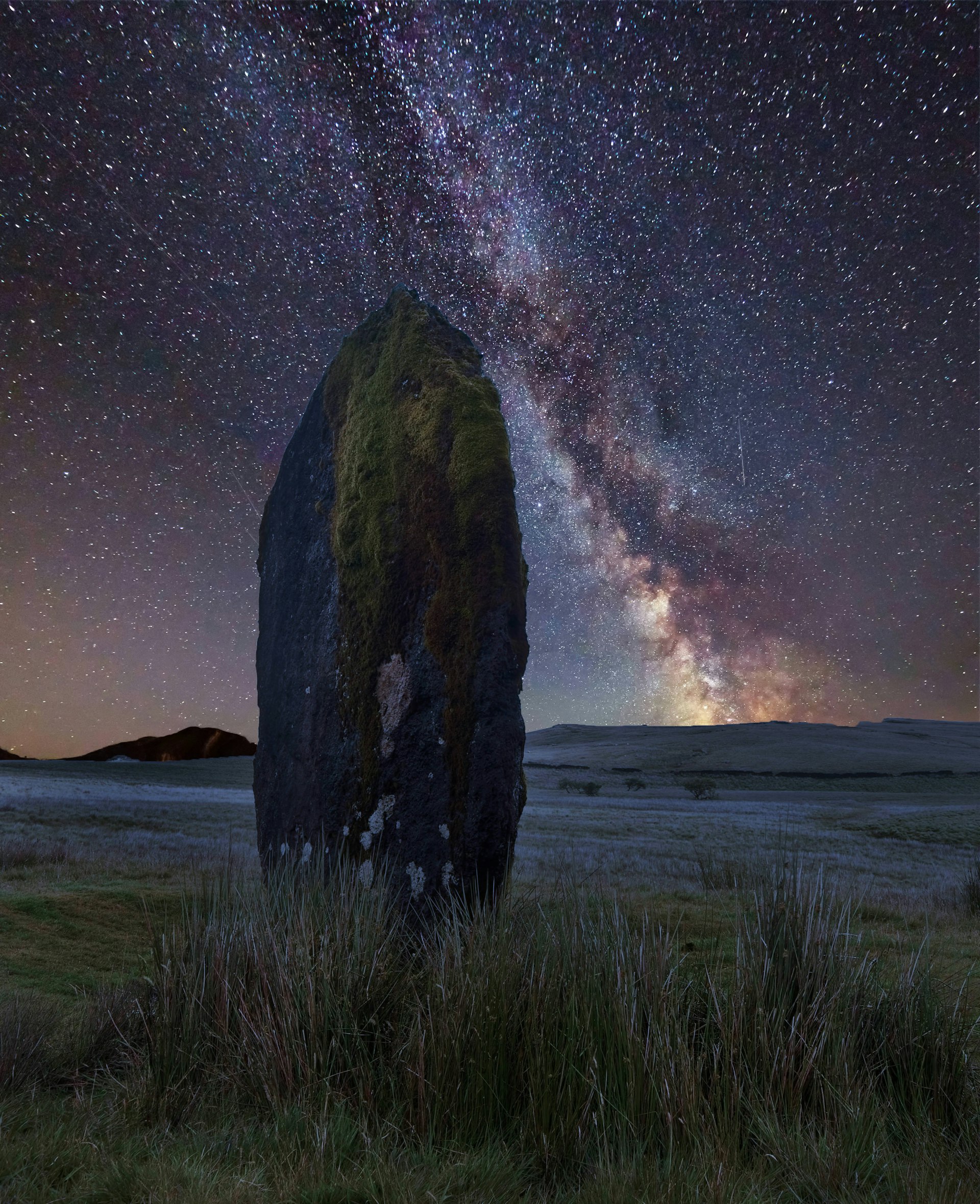 Night sky with the Milky Way over landscape of ancient prehistoric stones in Brecon Beacons National Park, Wales