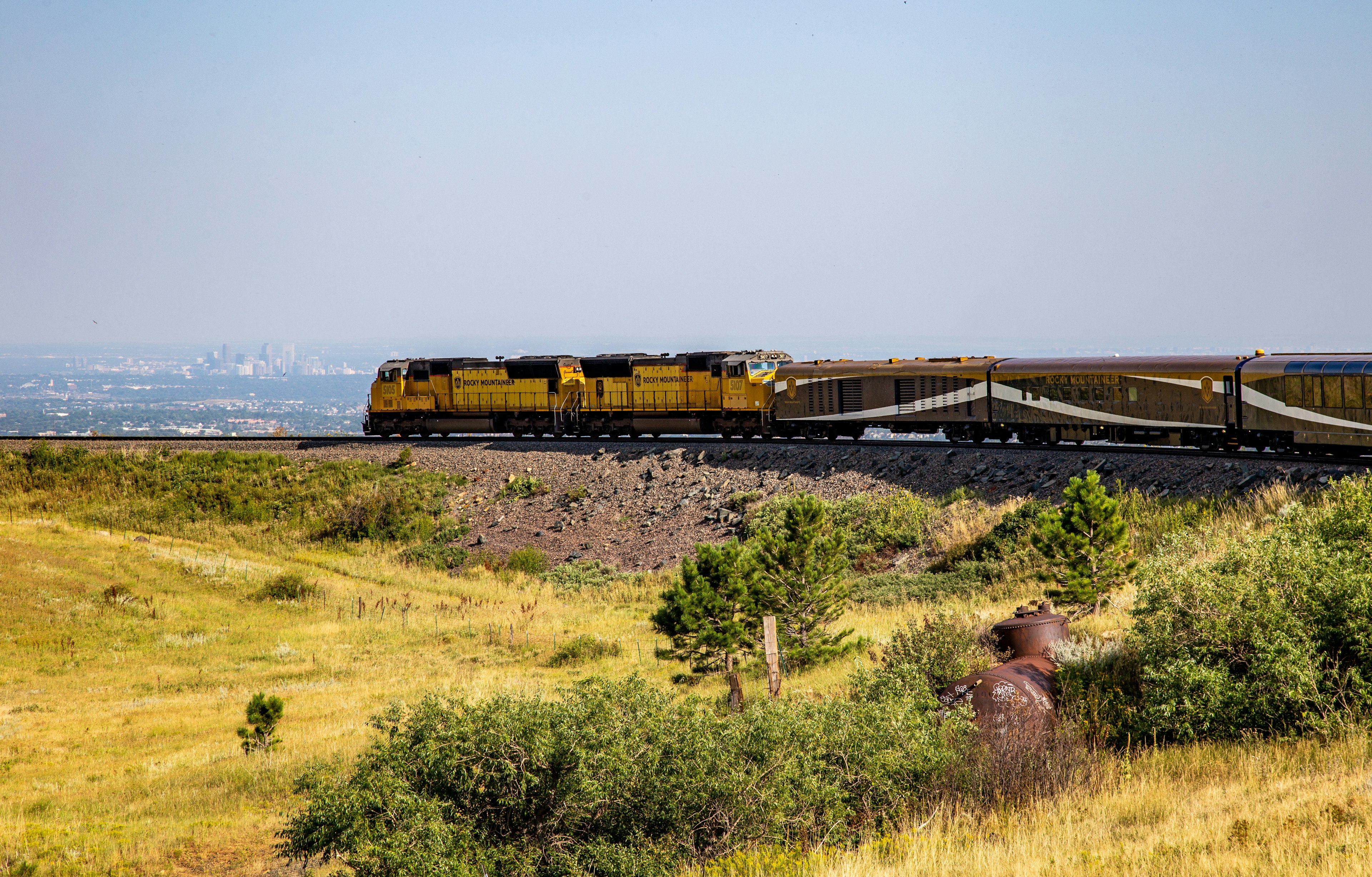 A train rounding a bend, with a city in the distance