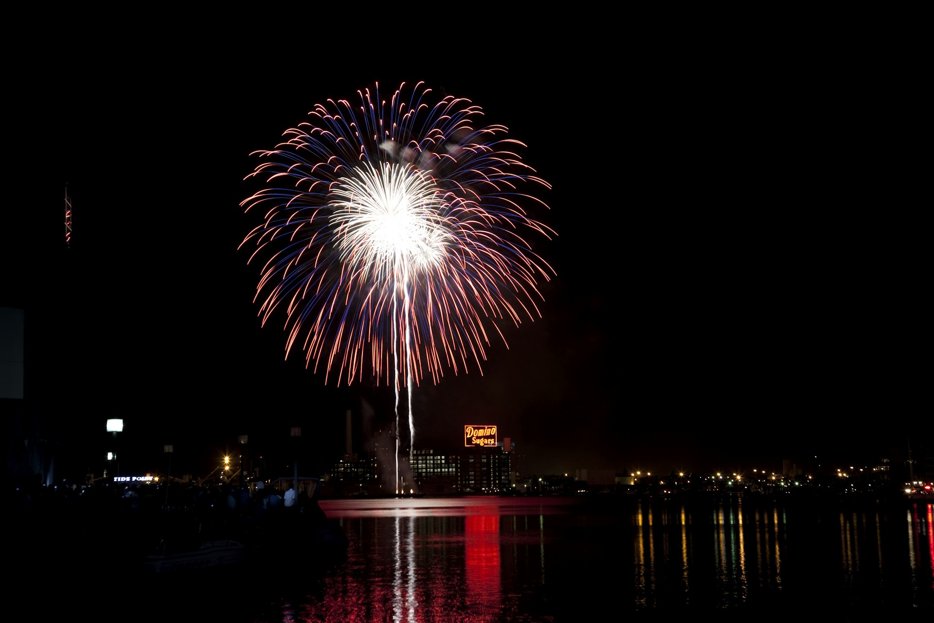 A large firework explodes over the Inner Harbor in Baltimore on the Fourth of July.