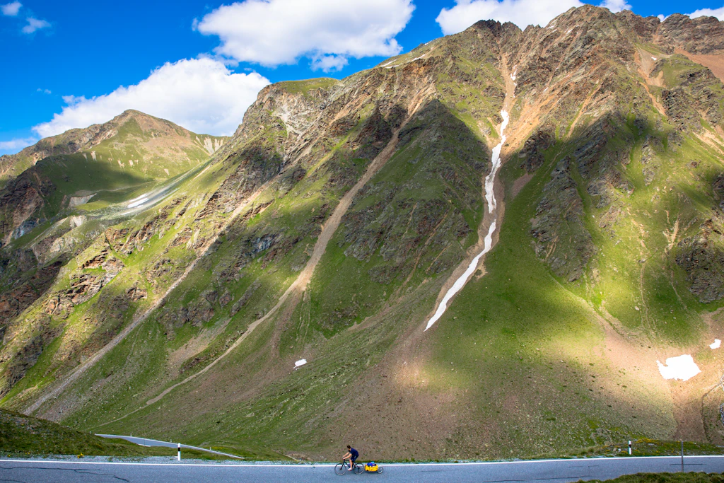 Cyclist on Umbrail Pass in the Alps, Switzerland