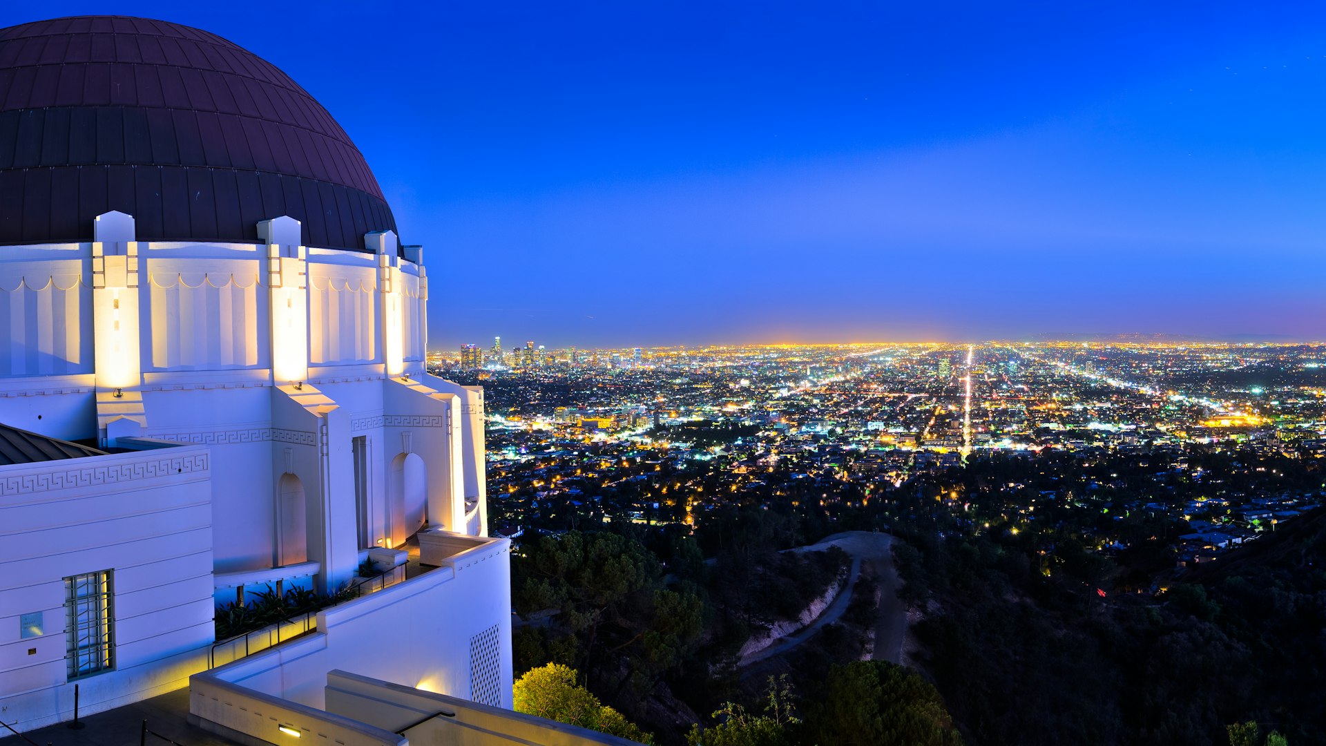 An observatory overlooking a cityscape during the blue hour