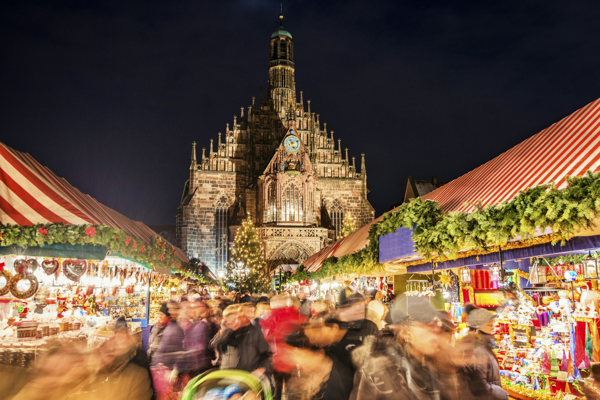 People walking through stalls at the Christmas Market in Nuremberg, Germany