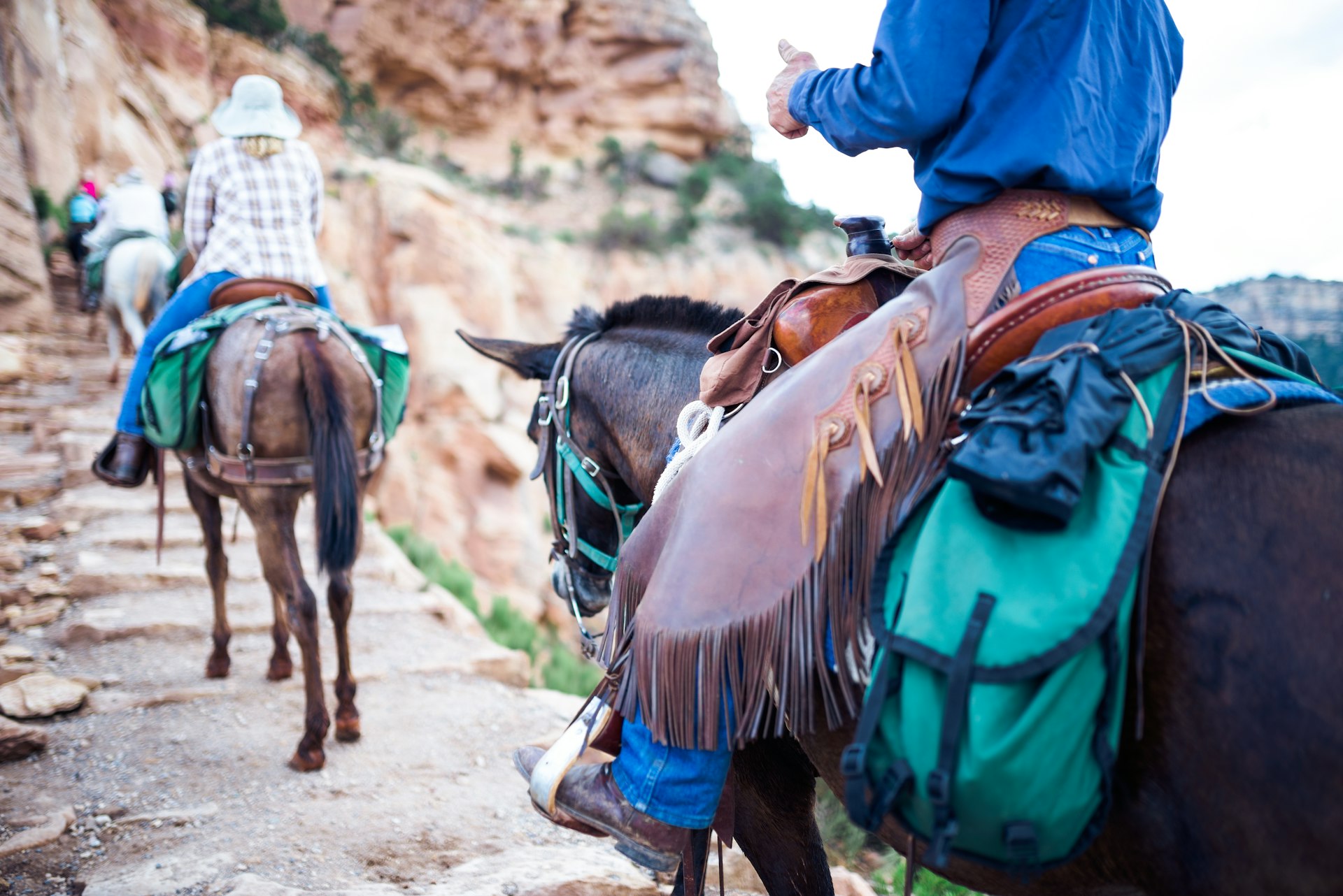Riding on horseback through a canyon