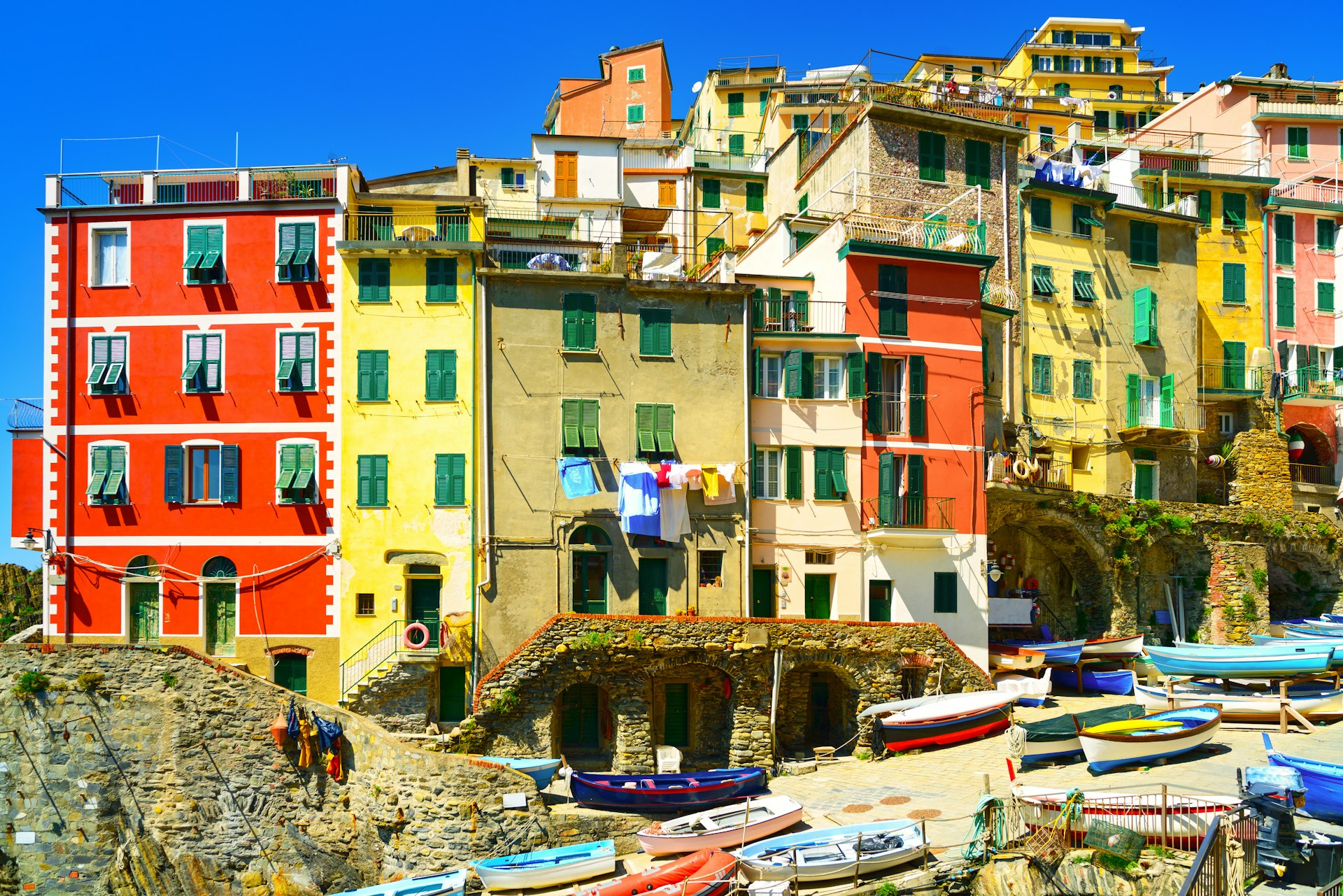 Village street in Riomaggiore, Cinque Terre, with boats and colorful houses
