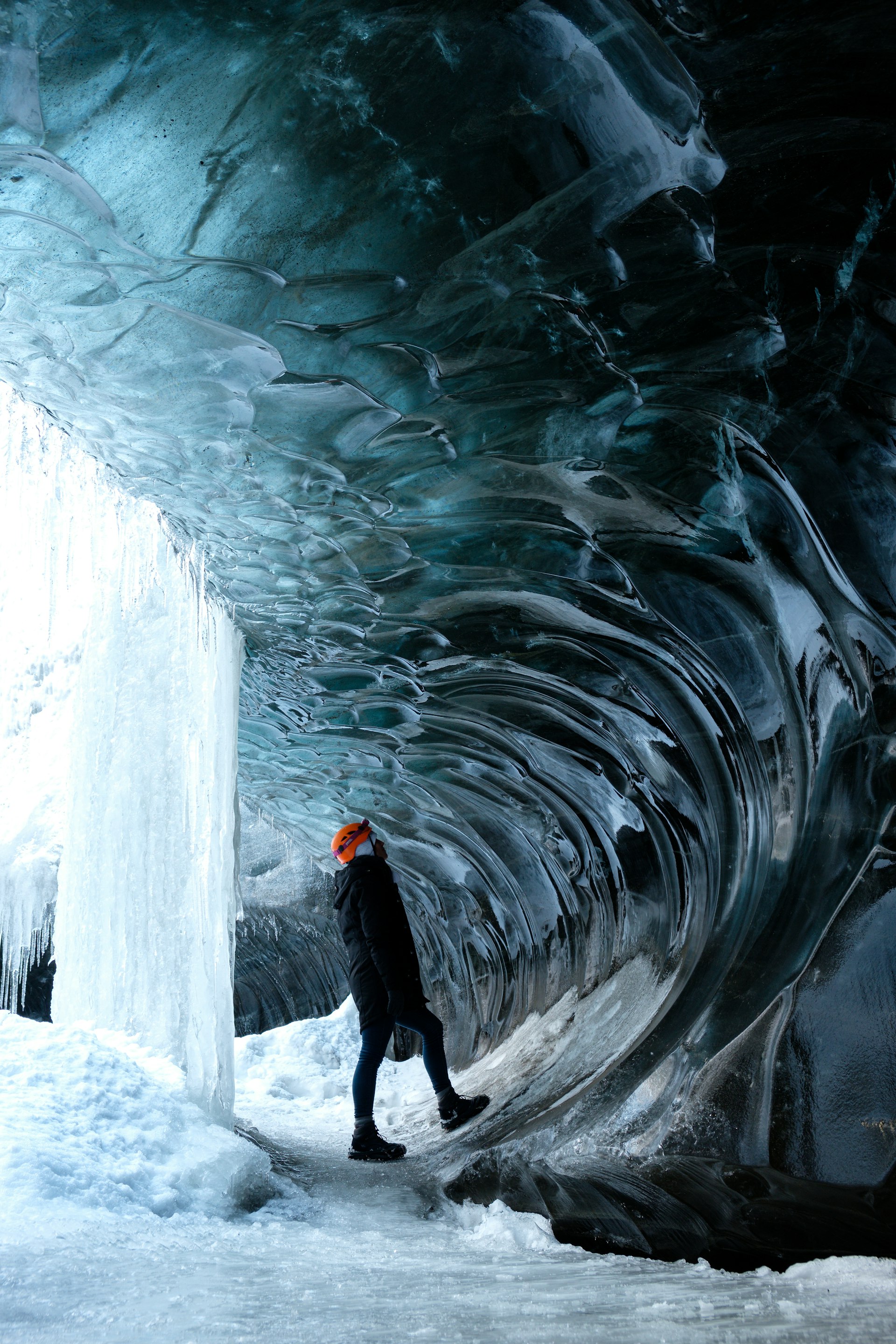 A woman looking at an ice cave Vatnajökull Iceland