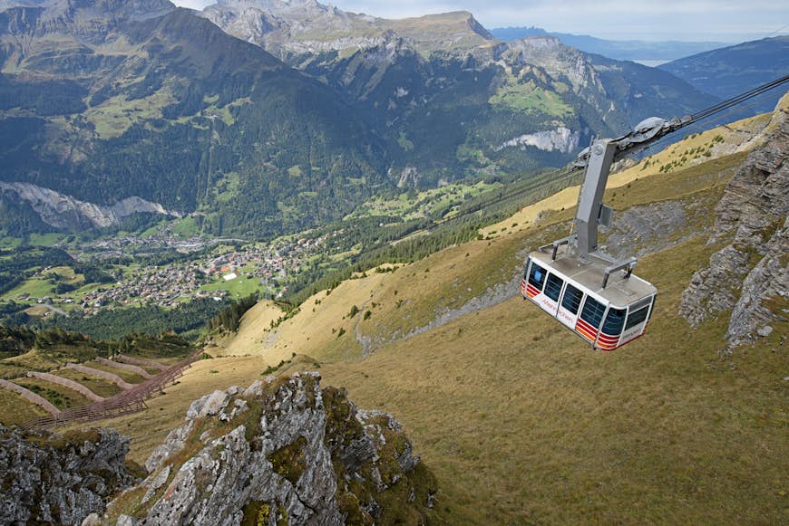 A cable car dangles high above the Lauterbrunnen Valley in Switzerland