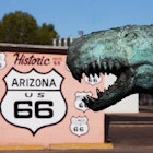 Close up of dinosaur statue by Historic Route 66 sign, Holbrook, Arizona, United States