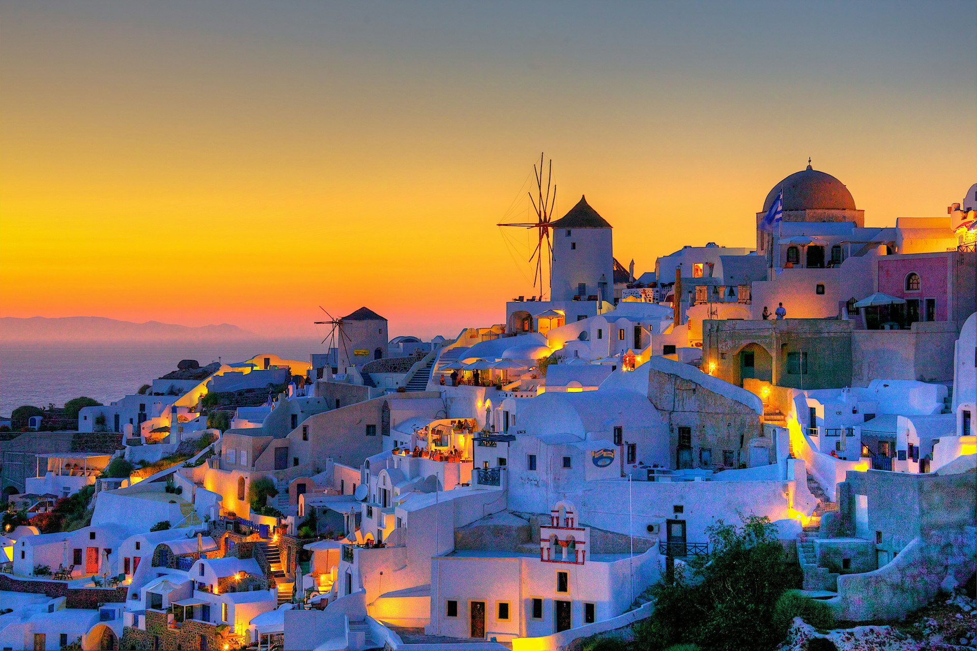 A magical Santorini sunset over the white-washed houses in Oia