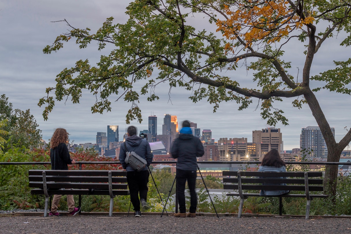 MINNEAPOLIS, MN - FALL 2018 - A Twilight Shot of Photographers Enjoying the View of the Minneapolis Skyline from Tower Hill Park; © Sam Wagner/ Shutterstock