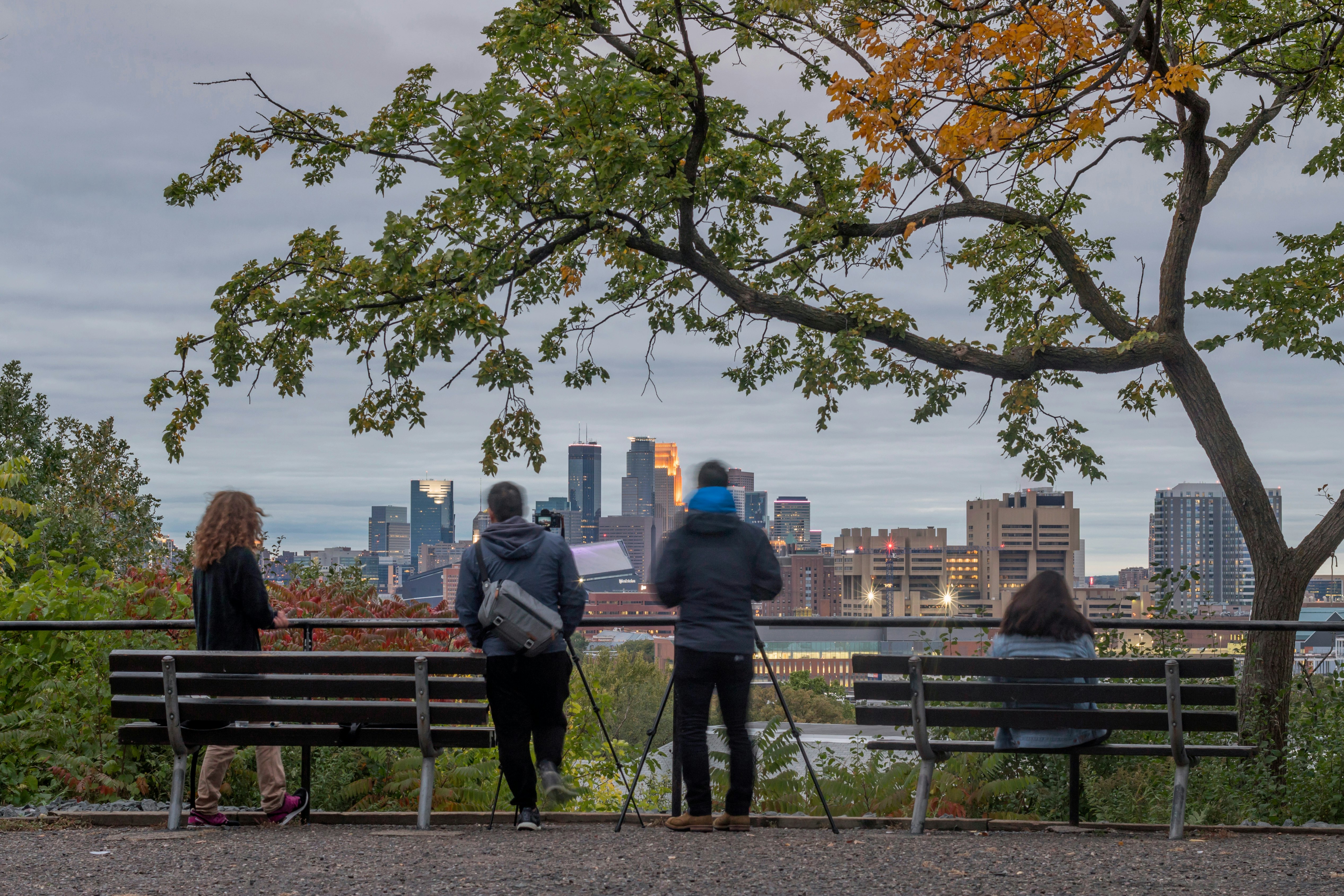 A twilight shot of photographers enjoying the view of the Minneapolis skyline from Tower Hill Park