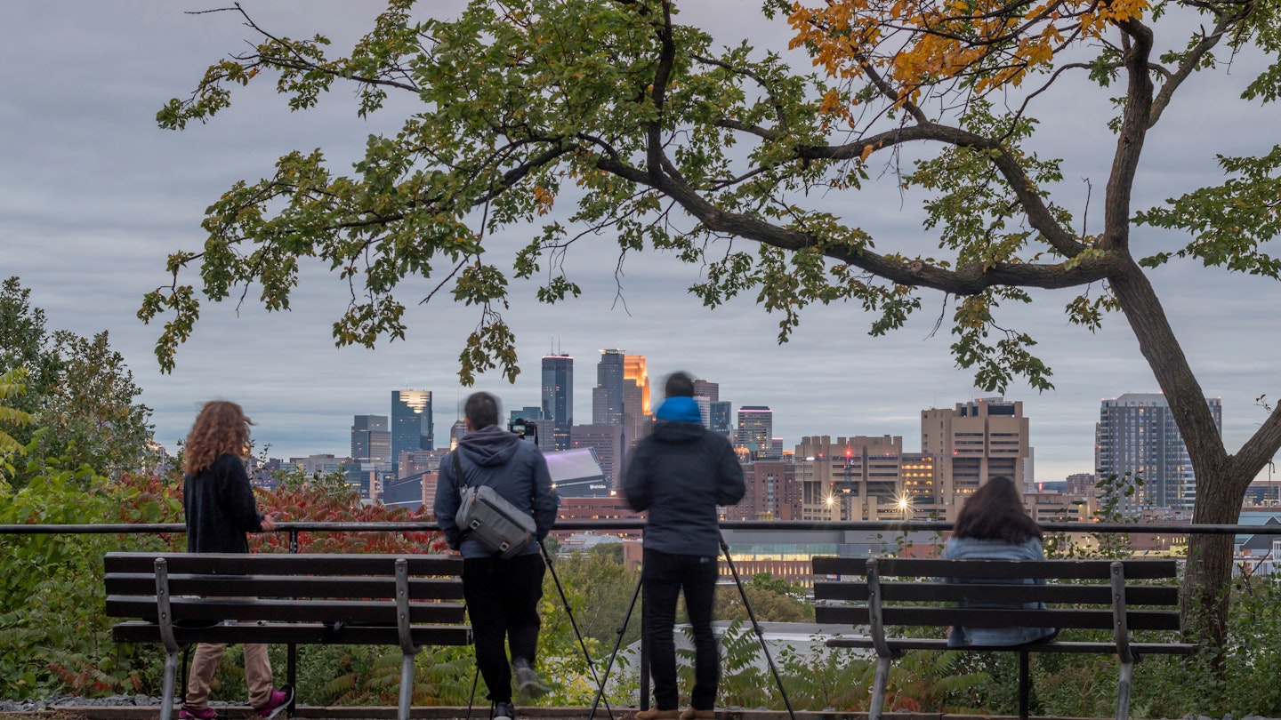 MINNEAPOLIS, MN - FALL 2018 - A Twilight Shot of Photographers Enjoying the View of the Minneapolis Skyline from Tower Hill Park; © Sam Wagner/ Shutterstock