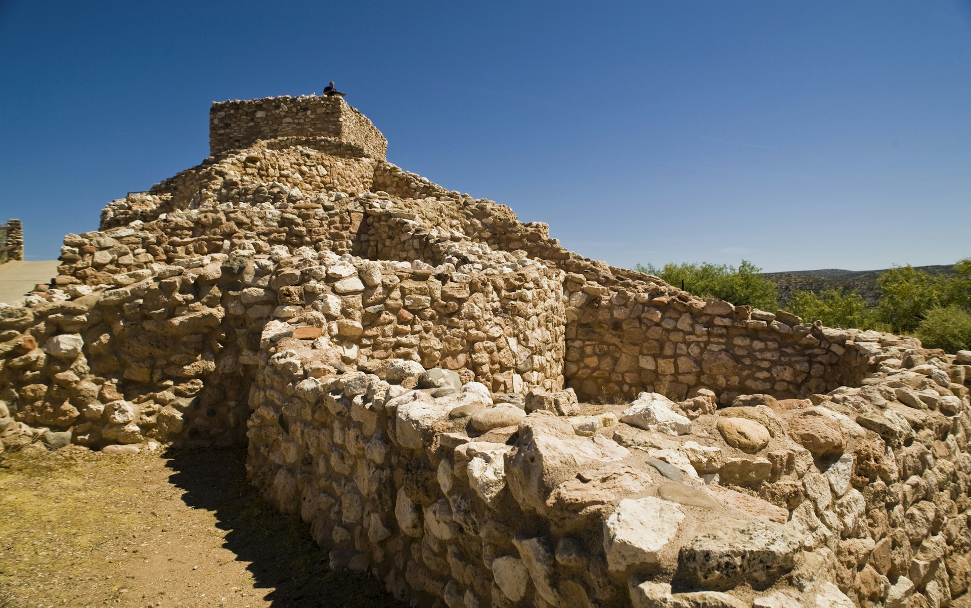 Stone foundations of the pueblo at Tuzigoot National Monument in Arizona on a sunny day