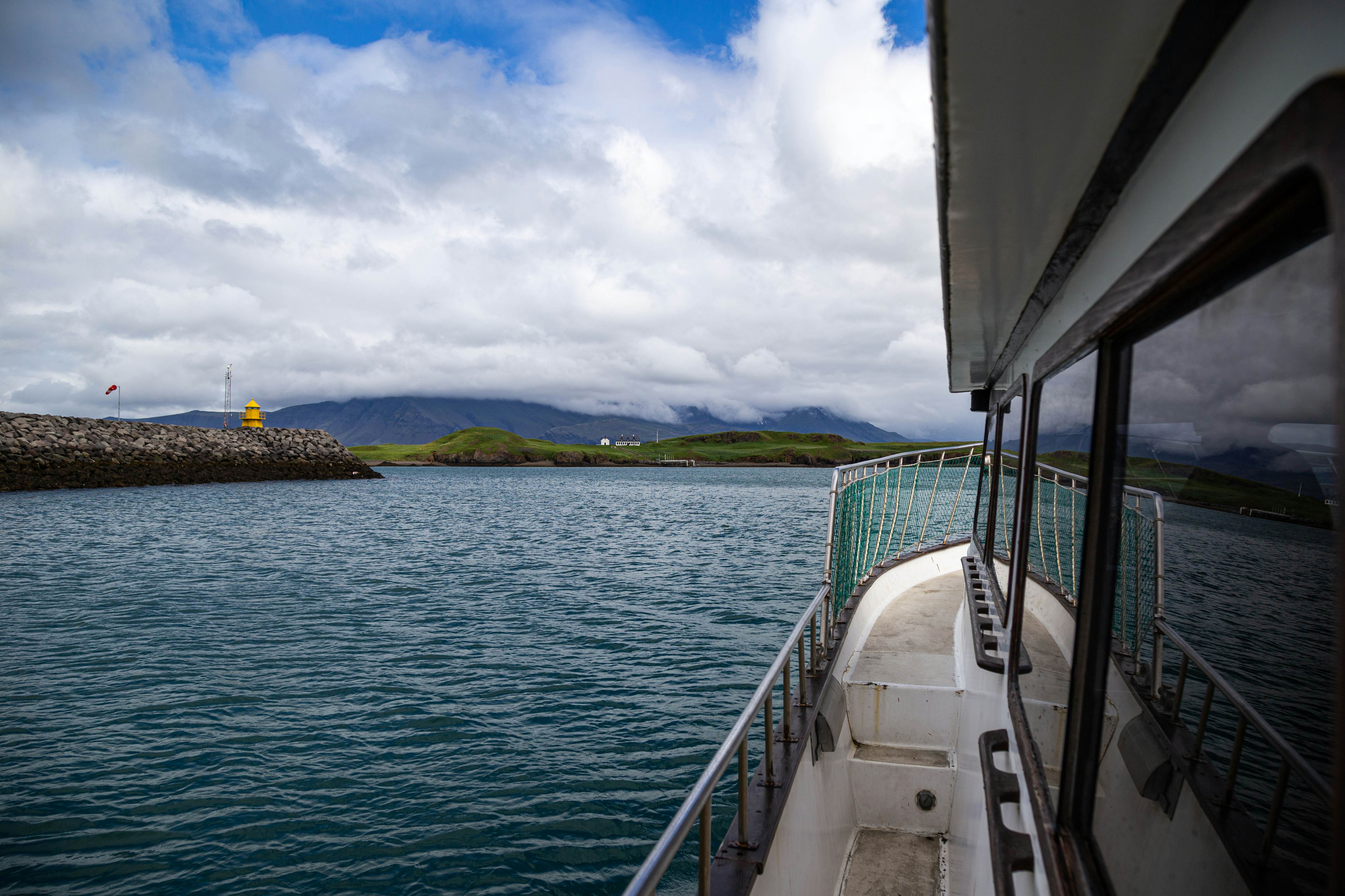 The view from aboard a small boat exiting a harbor