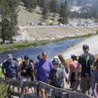 YELLOWSTONE NATIONAL PARK, WY - JULY 14: Tourists crowd in to the Midway Geyser Basin July 14, 2021 at Yellowstone National Park, Wyoming. Yellowstone is one of many national parks seeing record numbers of visitors this summer, leading to long lines and traffic jams. (Photo by Natalie Behring/Getty Images)