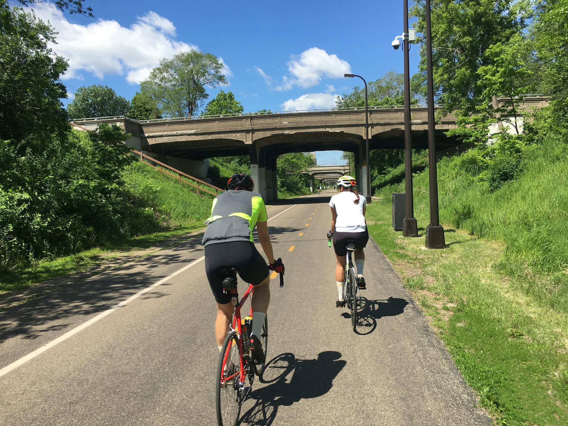 Two people cycling on a path in Minneapolis, Minnesota