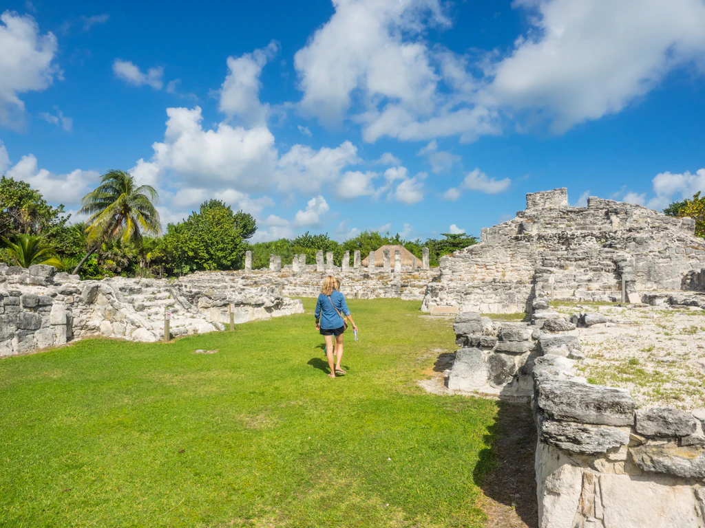Visitor walking at El Rey archaeological site in Cancun El Rey archaeological site in Cancun