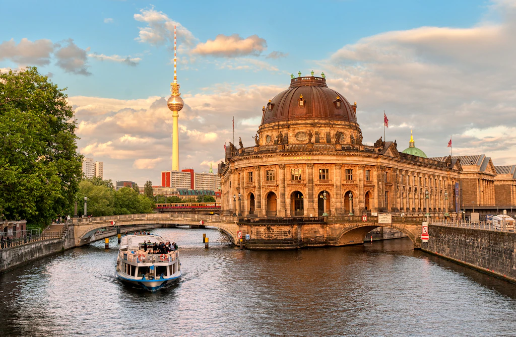 shutterstockRF_107513486.jpg Museumsinsel, a small island home to five museums, on the River Spree in Berlin. A passenger ferry passes the island on the river.