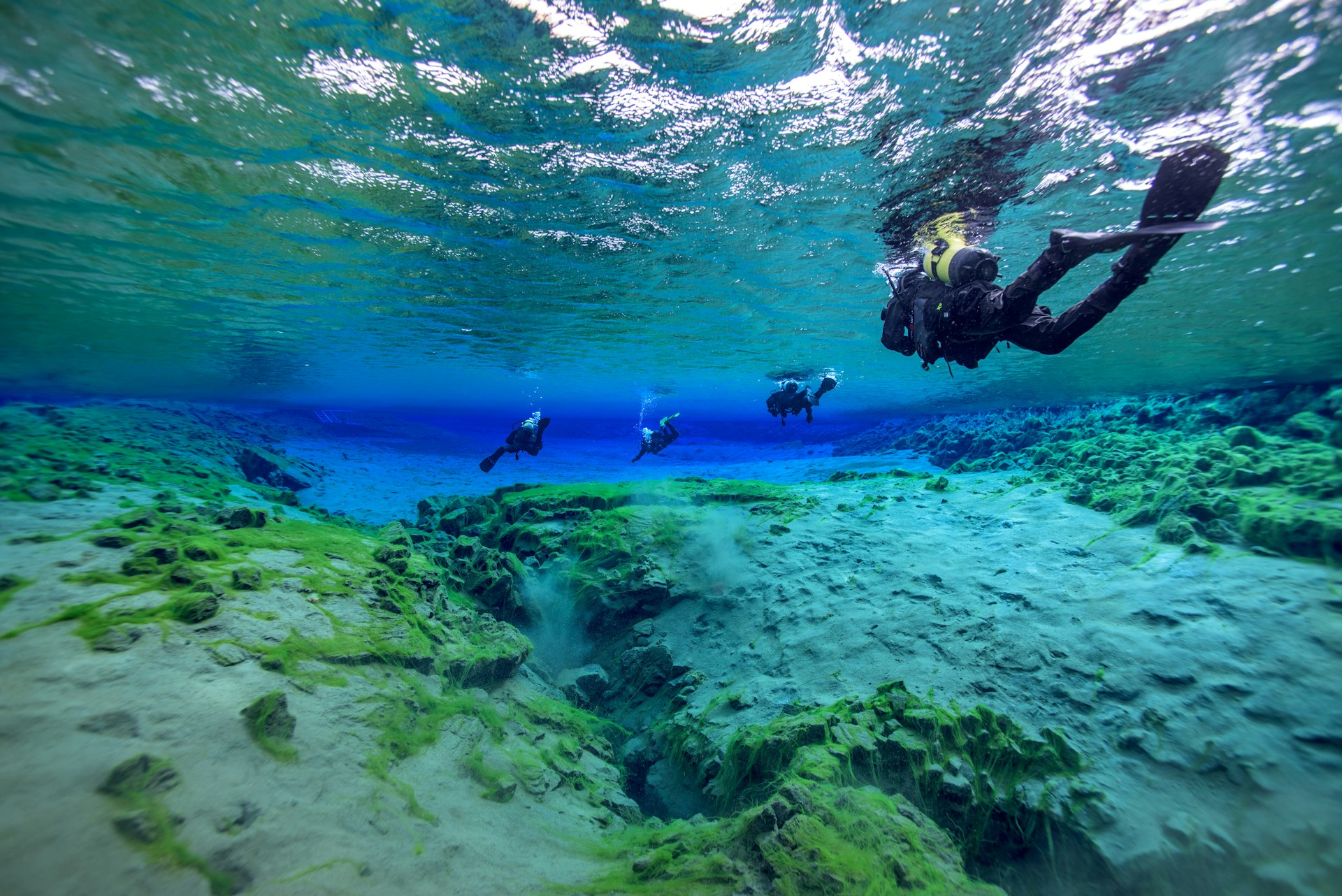 Man underwater diving in Þingvallavatn Lake along Silfra fissure, Iceland