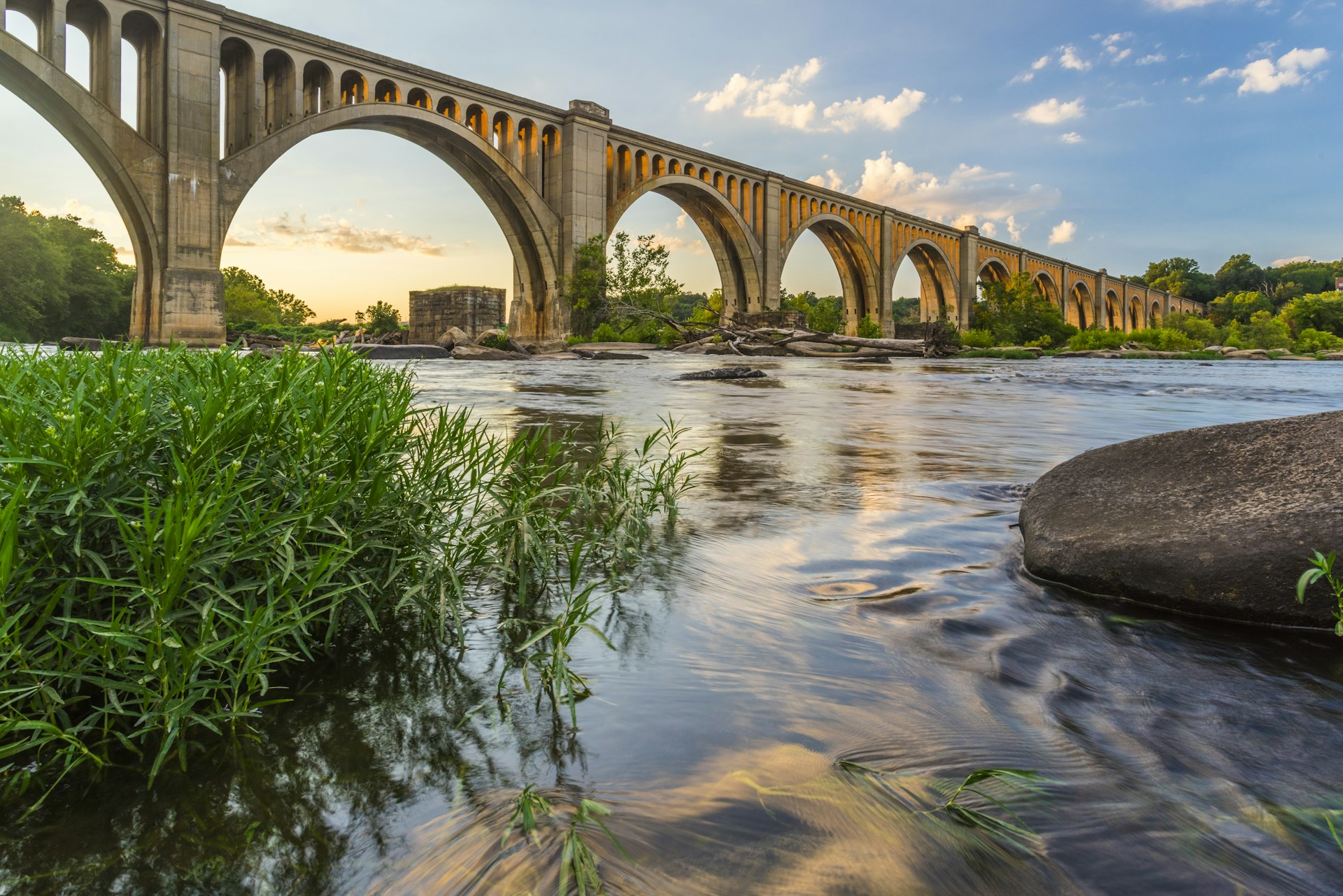 A concrete arch railroad bridge spanning the James River in Richmond, Virginia