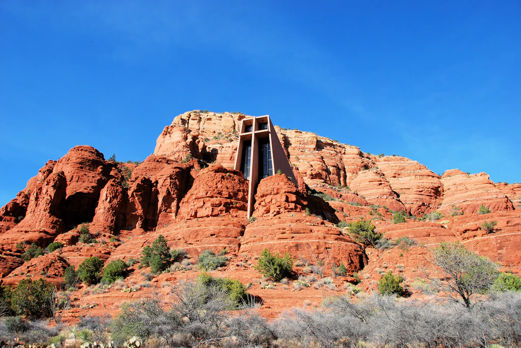 A structure built into a red-rock cliff
