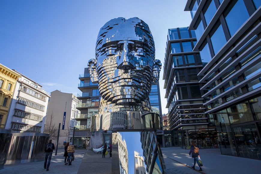 A giant metallic sculpture of the head of author Franz Kafka stands in the centre of a street in Prague.