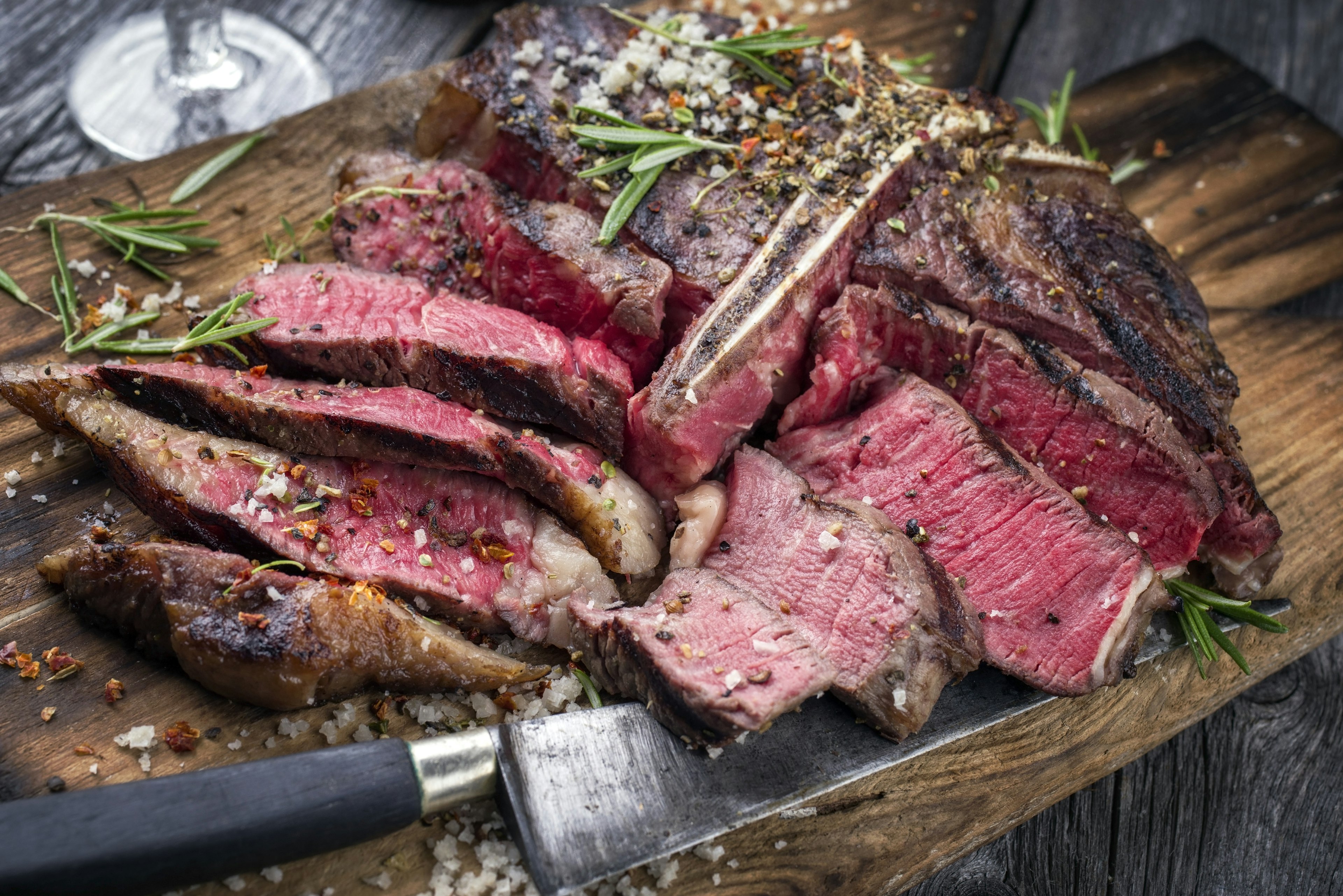 A sliced joint of beef, brown on the outside with red flesh inside