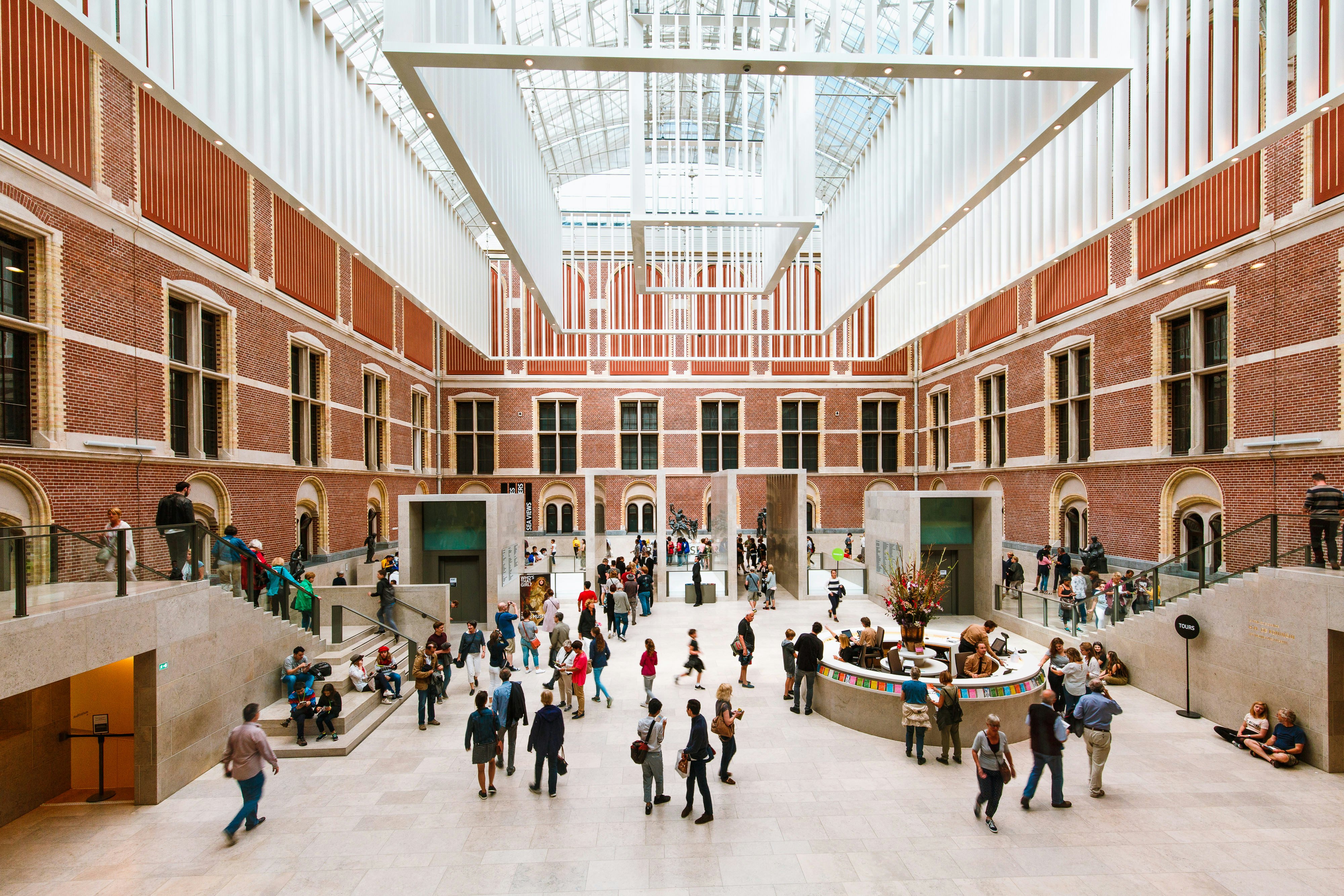 A huge atrium in the center of a museum packed with visitors