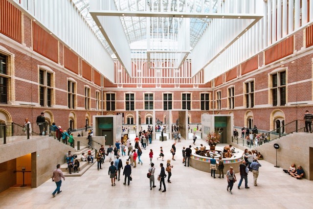 A huge atrium in the center of a museum packed with visitors