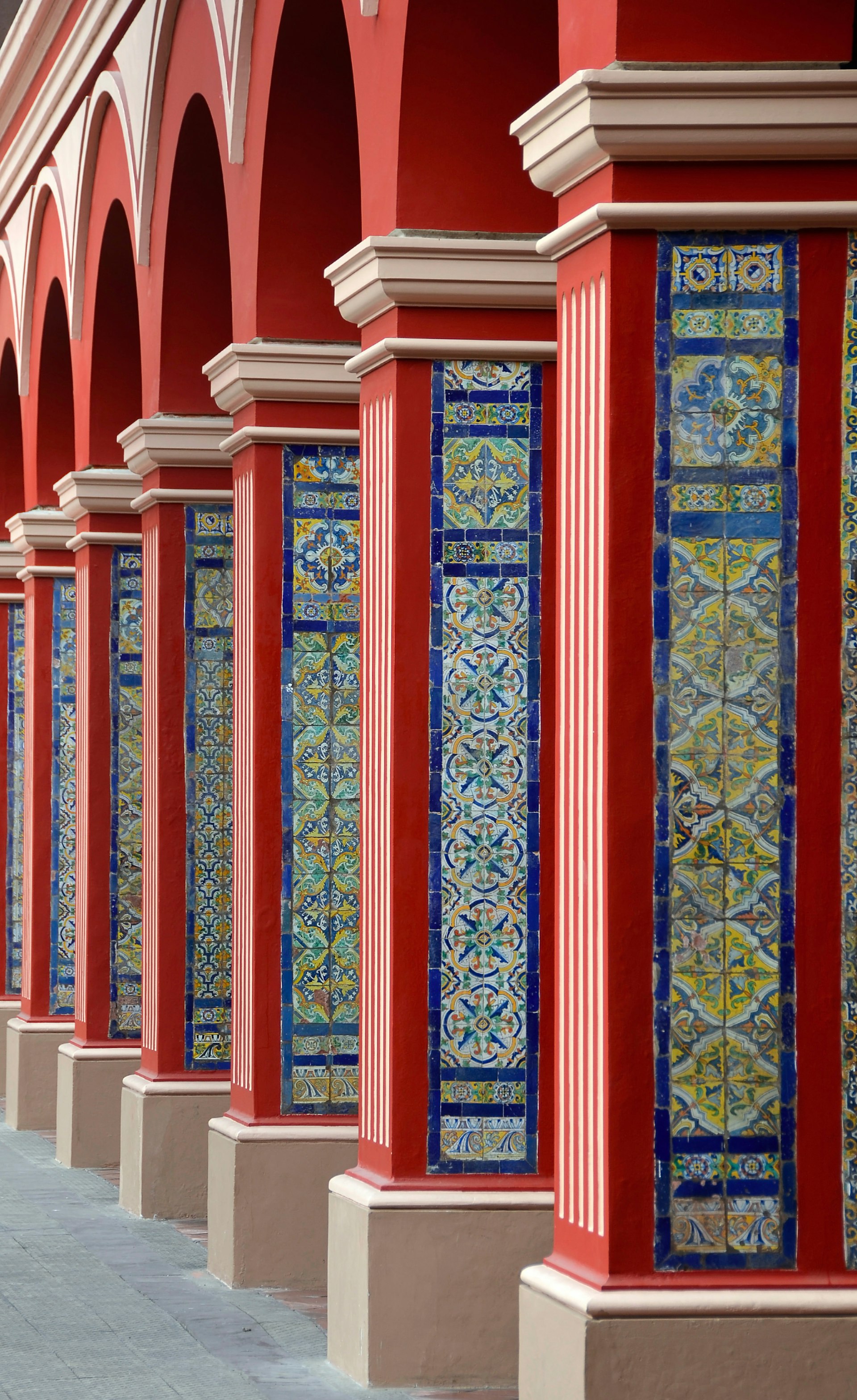 Red Arch Columns Pathway with Classic Colorful tiles in Lima Peru