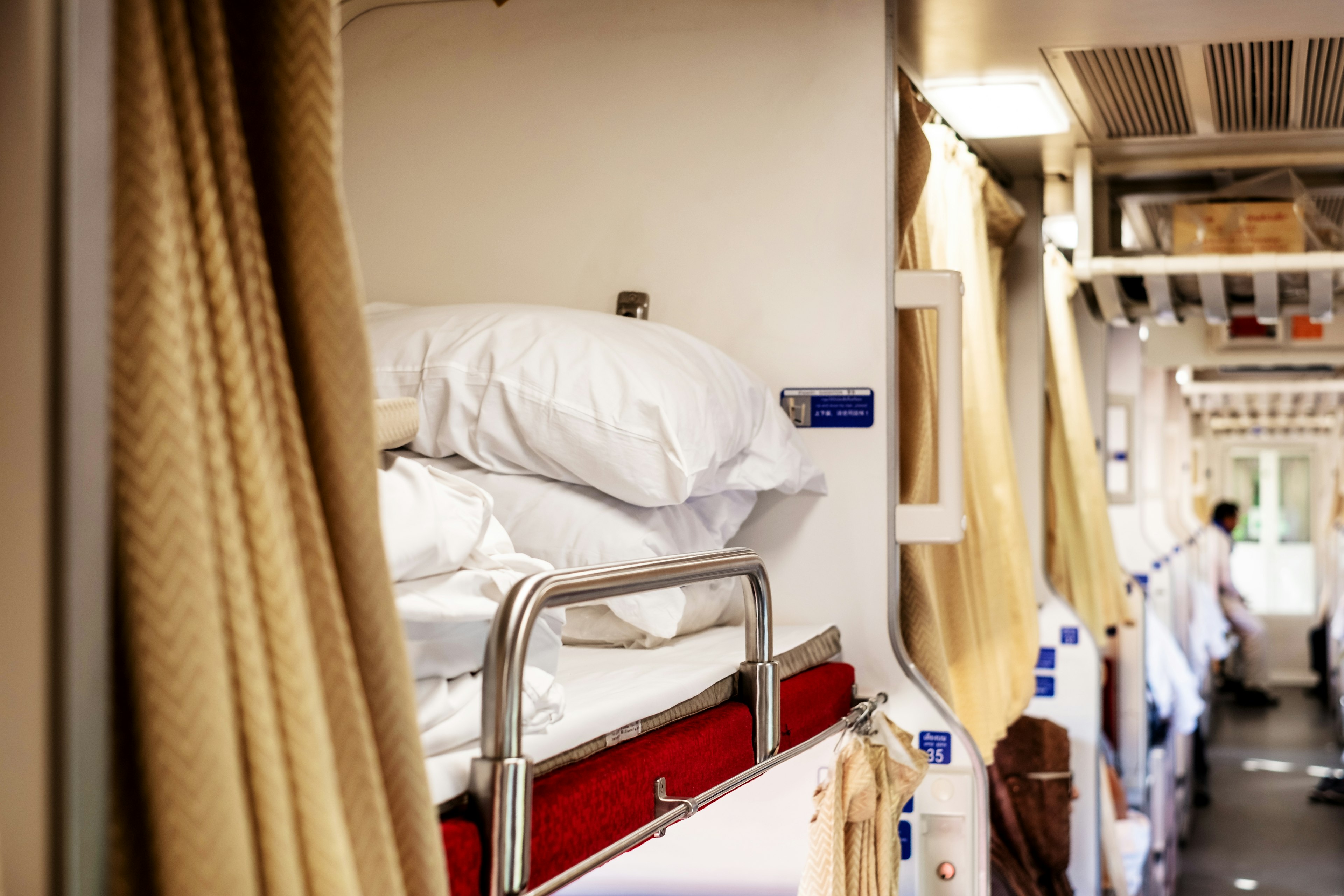 The inside second class sleeper cabin of Thai new express train with bedding