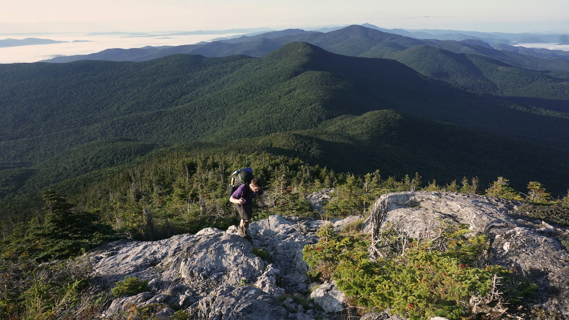 A hiker on the rocky Long Trail, Mt. Mansfield, Vermont